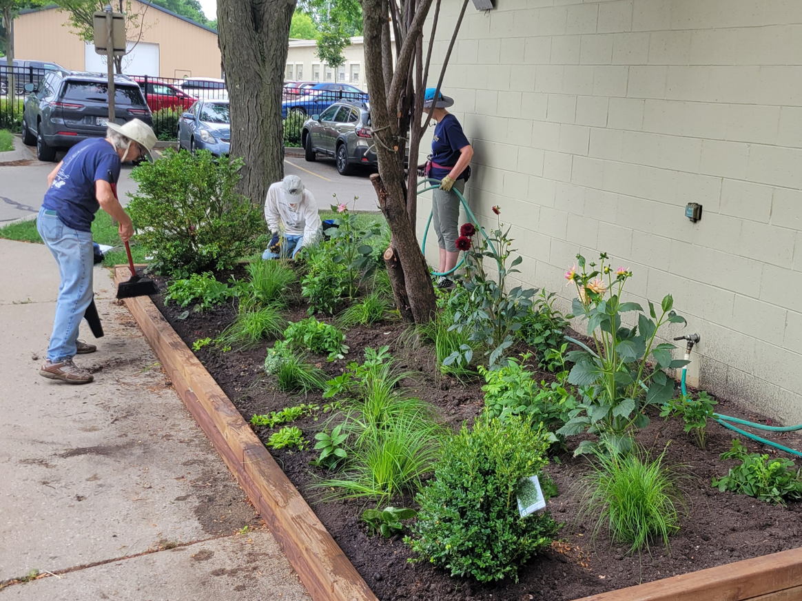 Volunteers planting garden outside Brinton Community Center