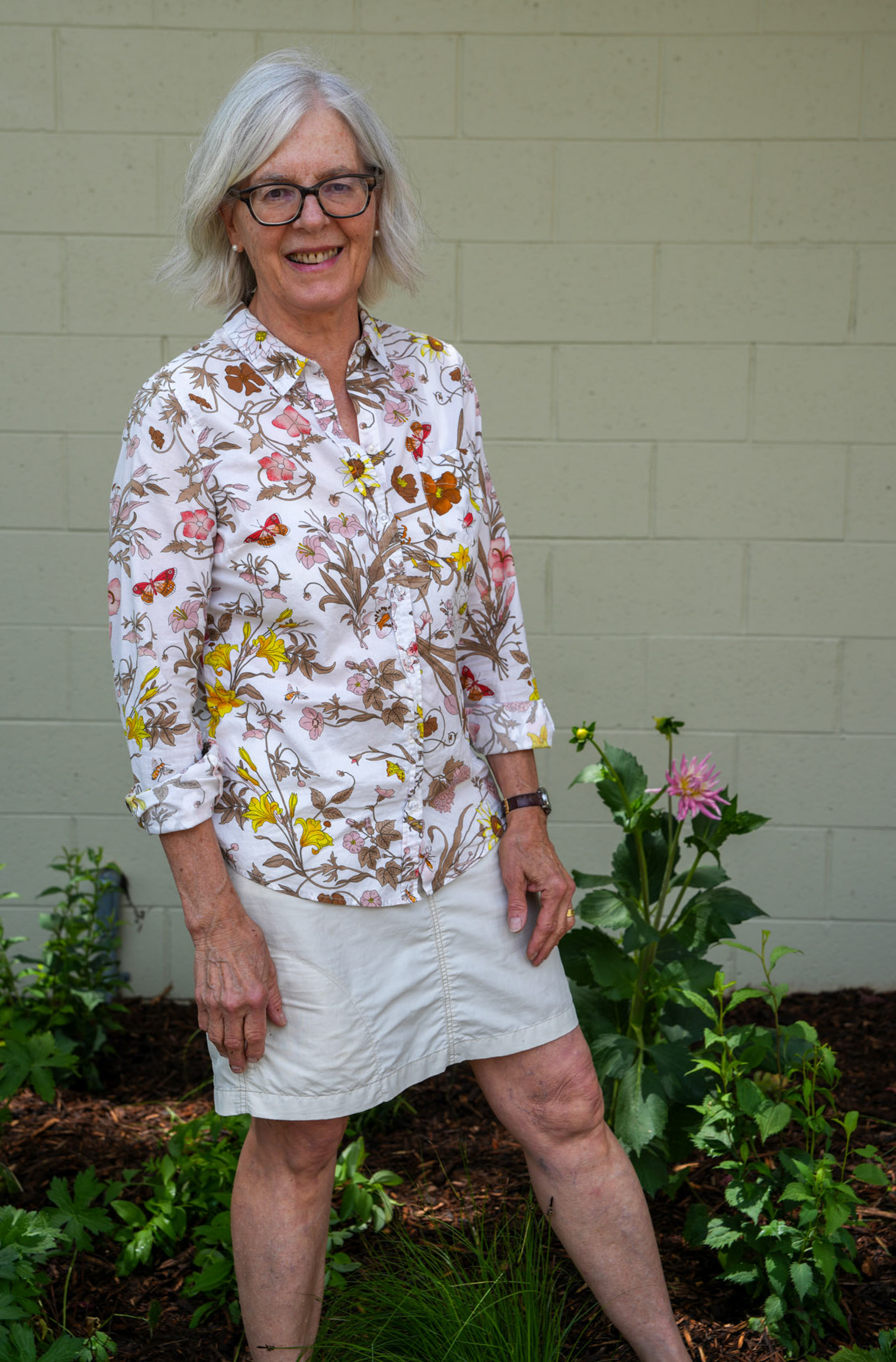 Angie Tornes in front of garden next to Brinton Community Center