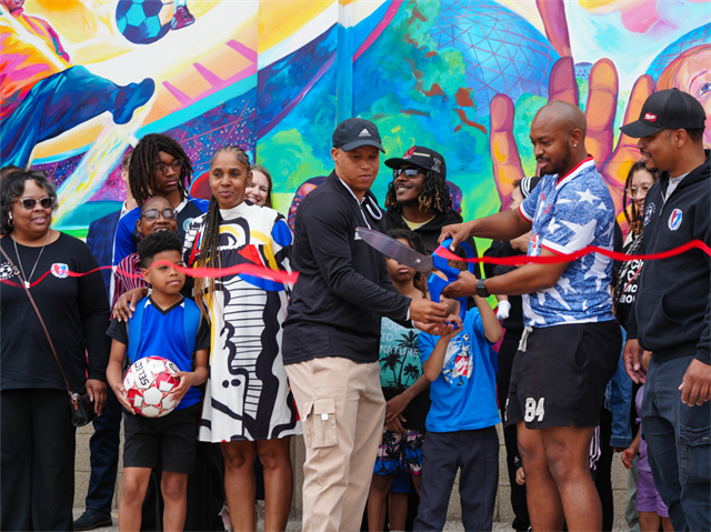 Jimmy Banks' sons cut the ribbon at the mural unveiling
